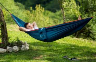A smaller image of a Via Dinarica hiker lying in a hammock